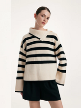 a lady in a black and white wool loose striped sweater